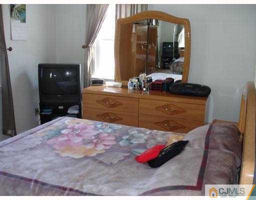 12 Old Post Road Edison, NJ 08817 - Photo 5 of 10 a bedroom with a bed and a mirror