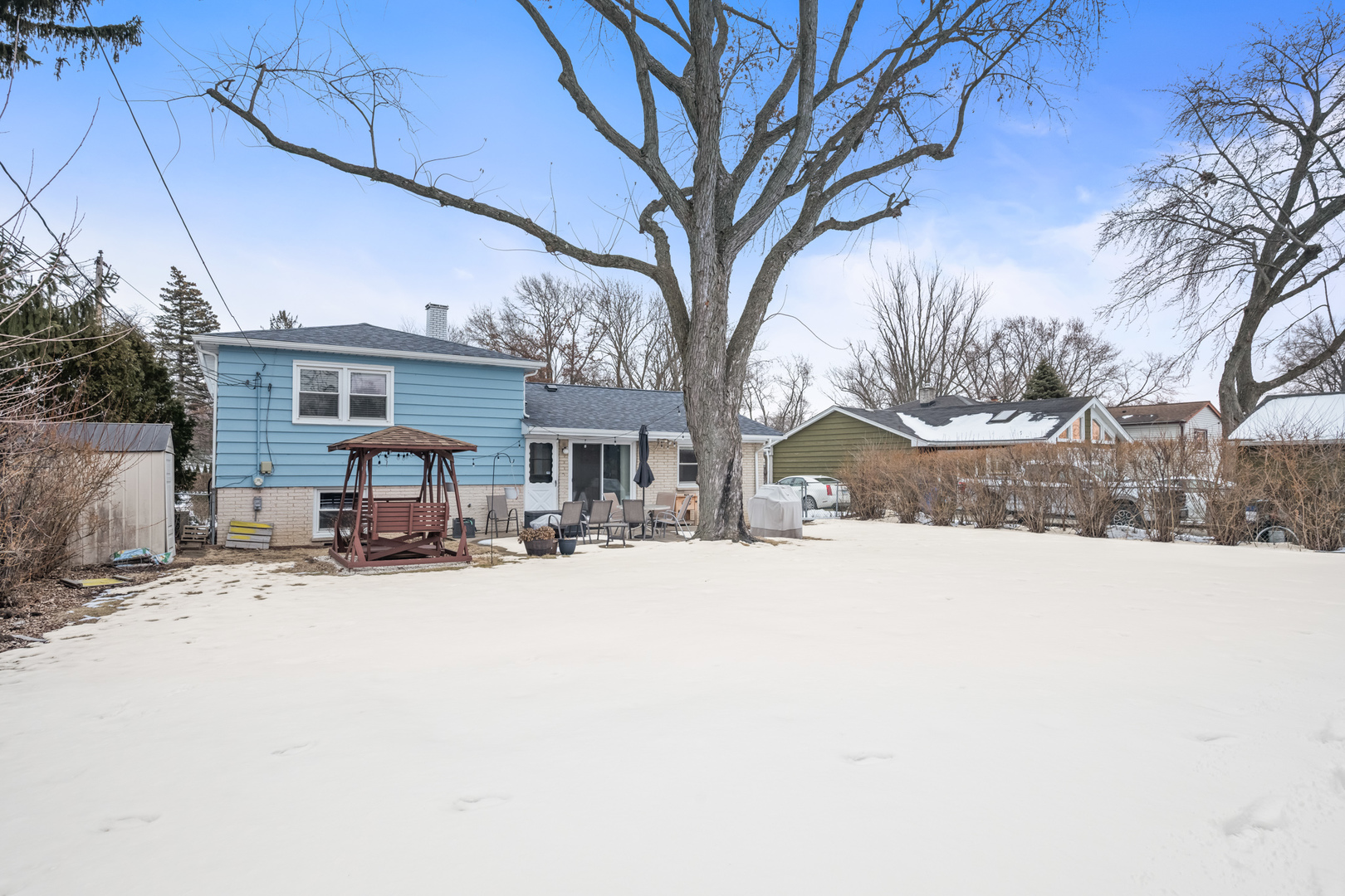 1414 Indigo Drive Mount Prospect, IL 60056 - Photo 22 of 32 a view of a house with a yard covered in snow