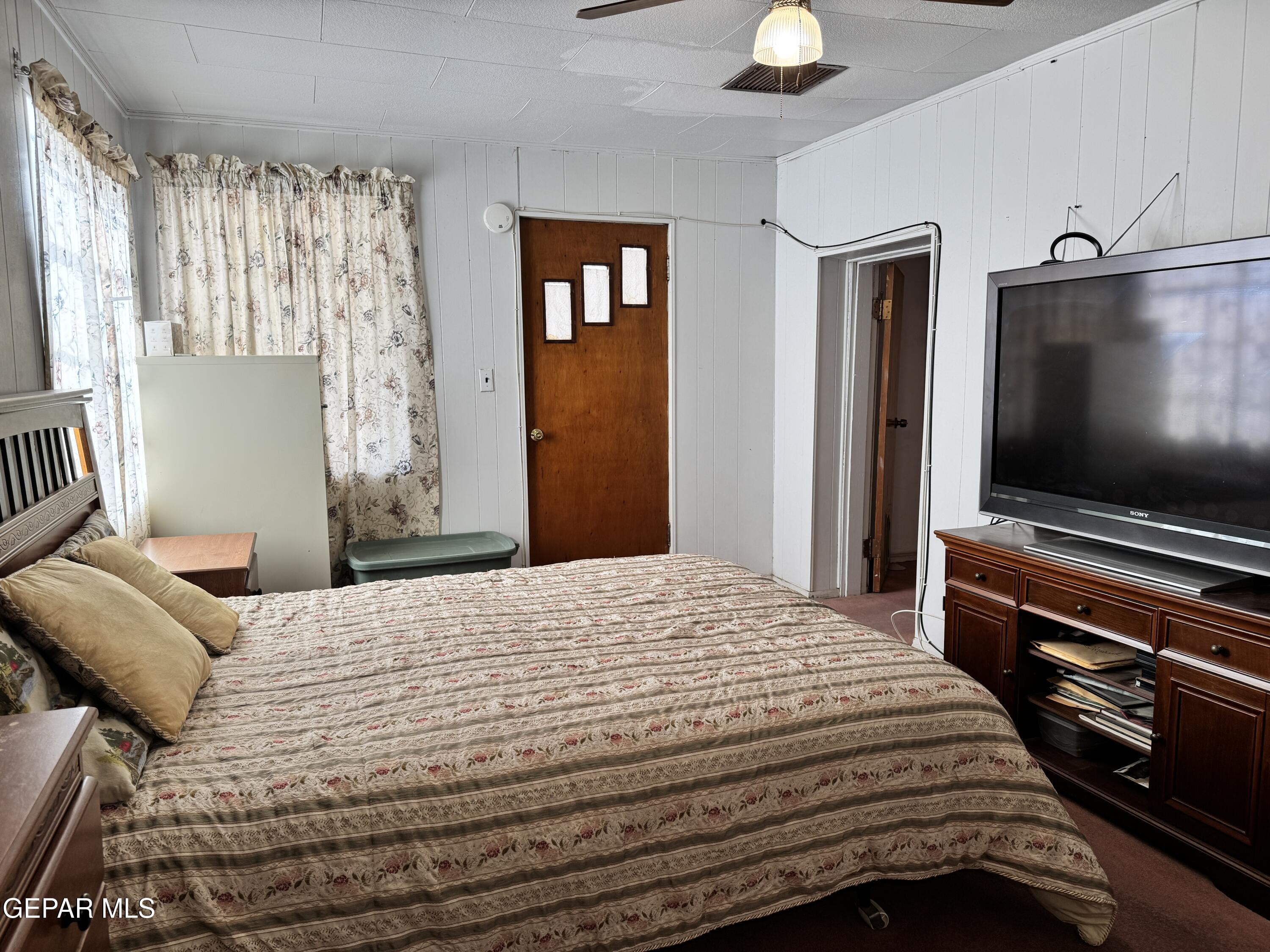 316 St Anthony Street Anthony, NM 88021 - Photo 12 of 29 a bedroom with a bed and a flat screen tv