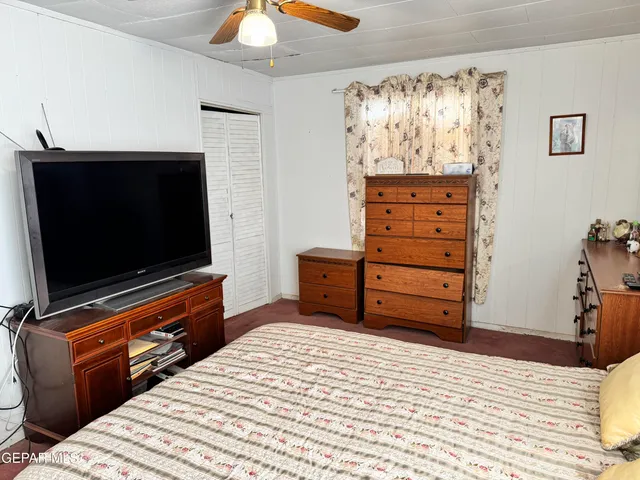 a room with a bed and a television