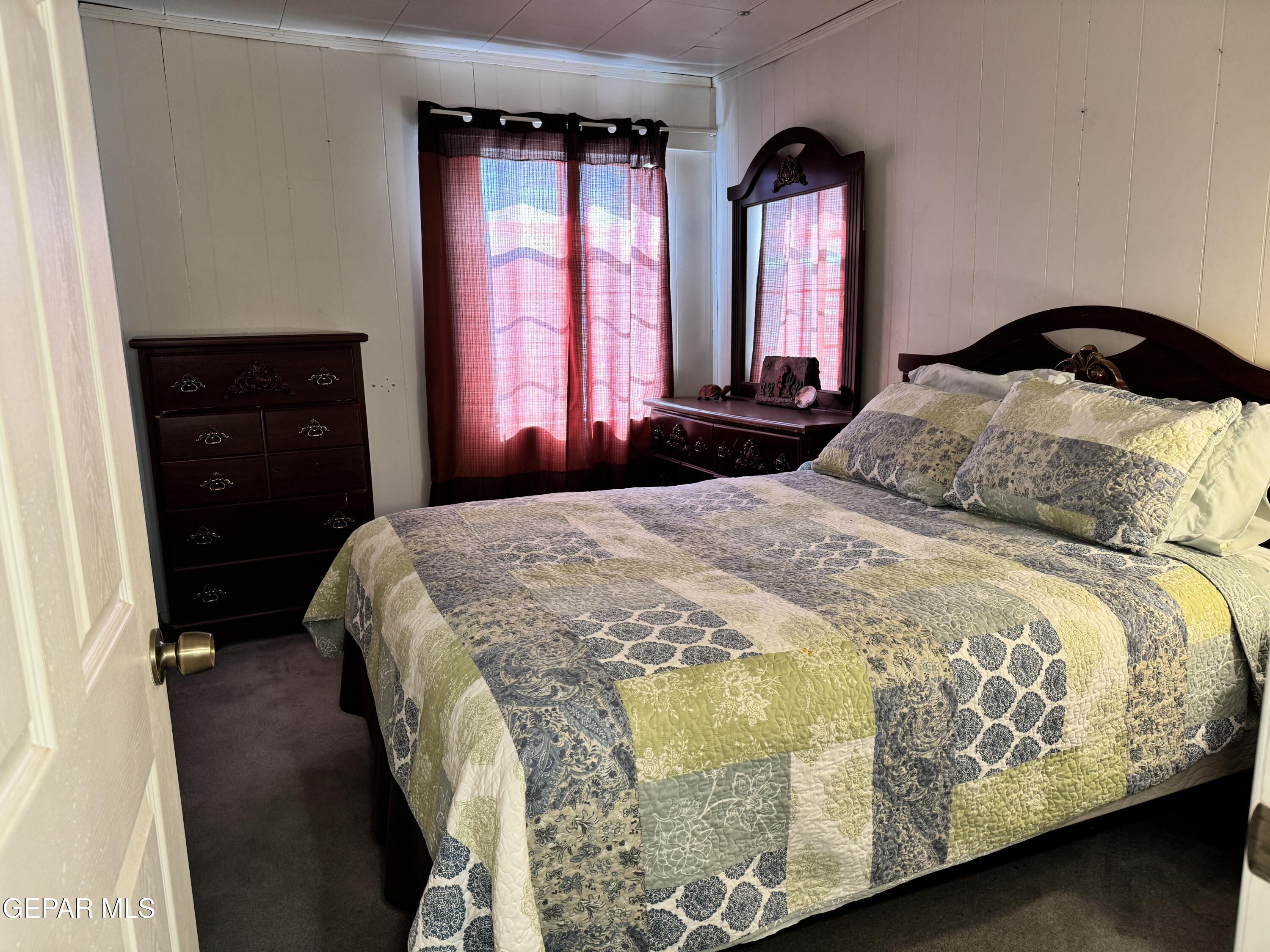 316 St Anthony Street Anthony, NM 88021 - Photo 16 of 29 a bedroom with a bed and a closet with mirror