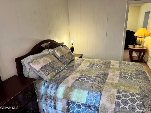 a bedroom with a bed and a chair