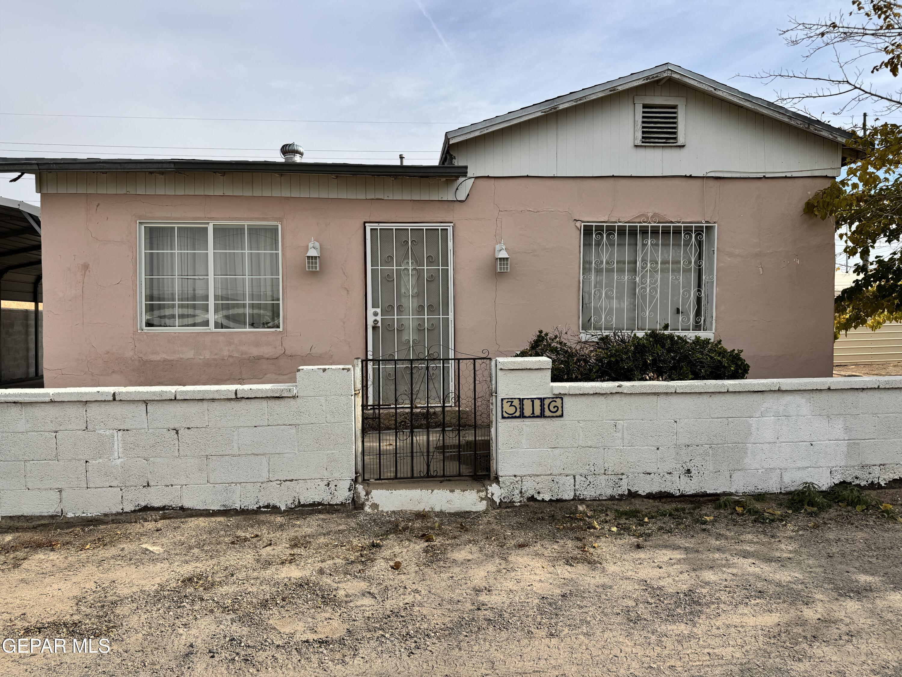 316 St Anthony Street Anthony, NM 88021 - Photo 3 of 29 a front view of a house with garage