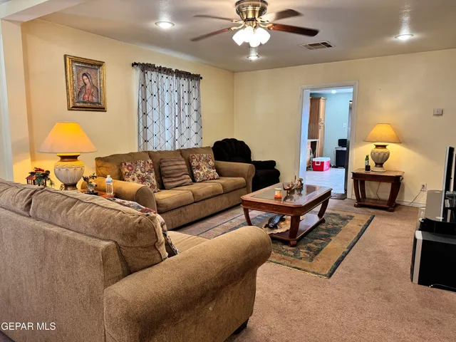 a living room with furniture a lamp and a chandelier