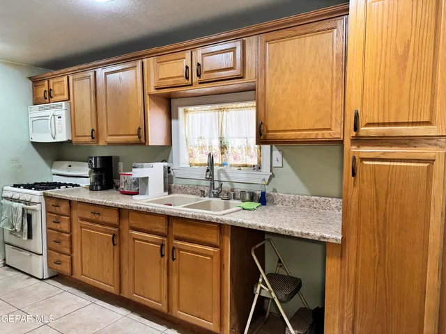 a kitchen with stainless steel appliances granite countertop a sink and a window