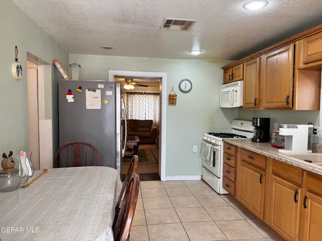 a kitchen with stainless steel appliances granite countertop a refrigerator and microwave