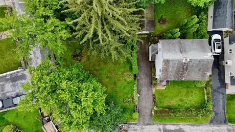 an aerial view of a house with a yard