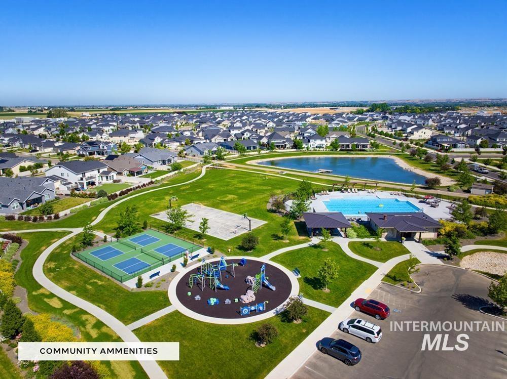 5897 West Riva Capri Street Meridian, ID 83646 - Photo 42 of 50 Expansive community park featuring a playground, multiple sports courts, a swimming pool, and a tranquil pond, surrounded by residential properties