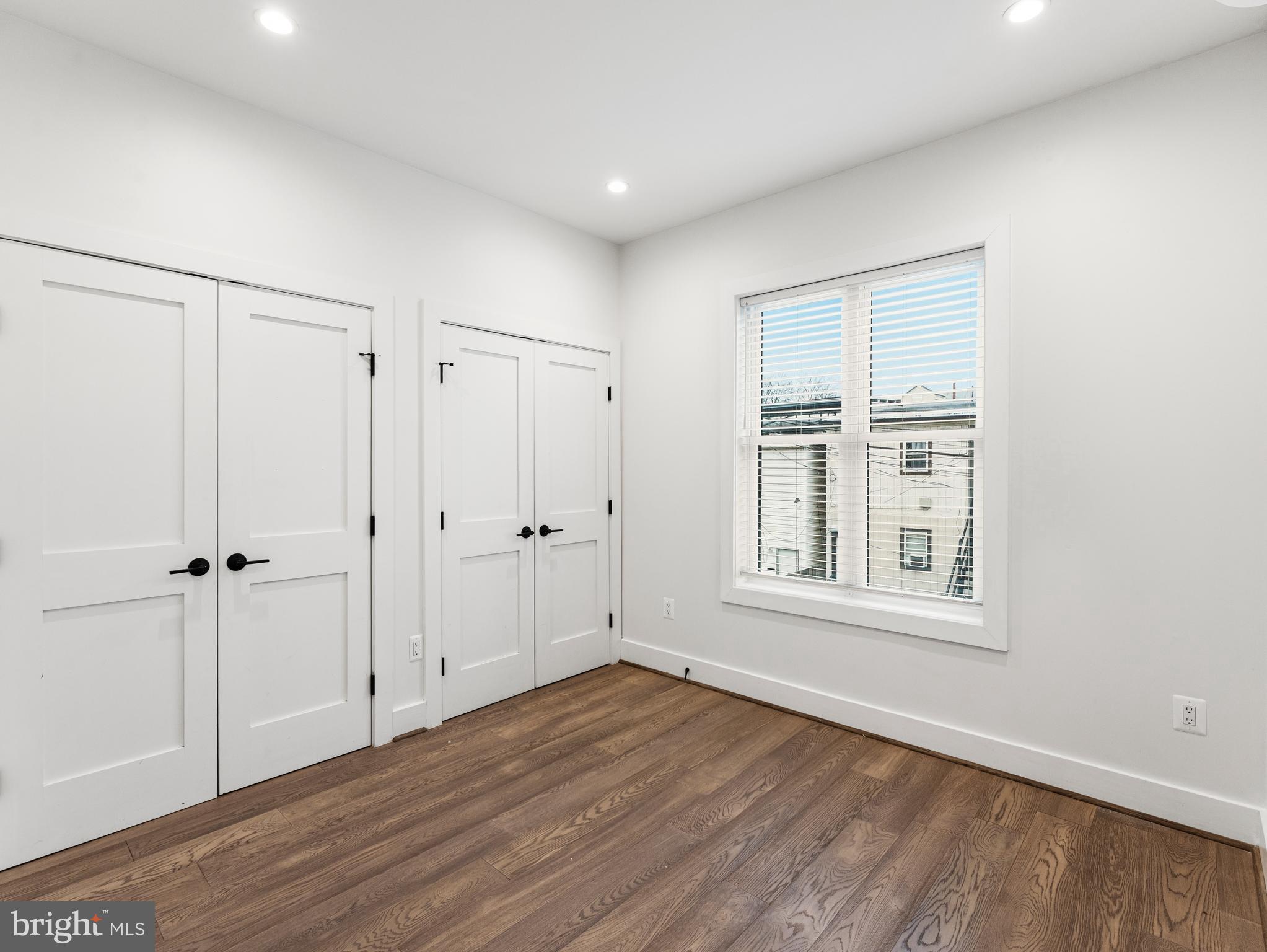 1120 Penn Street Northeast, Unit 2 Washington, DC 20002 - Photo 12 of 14 a view of an empty room with wooden floor and a window