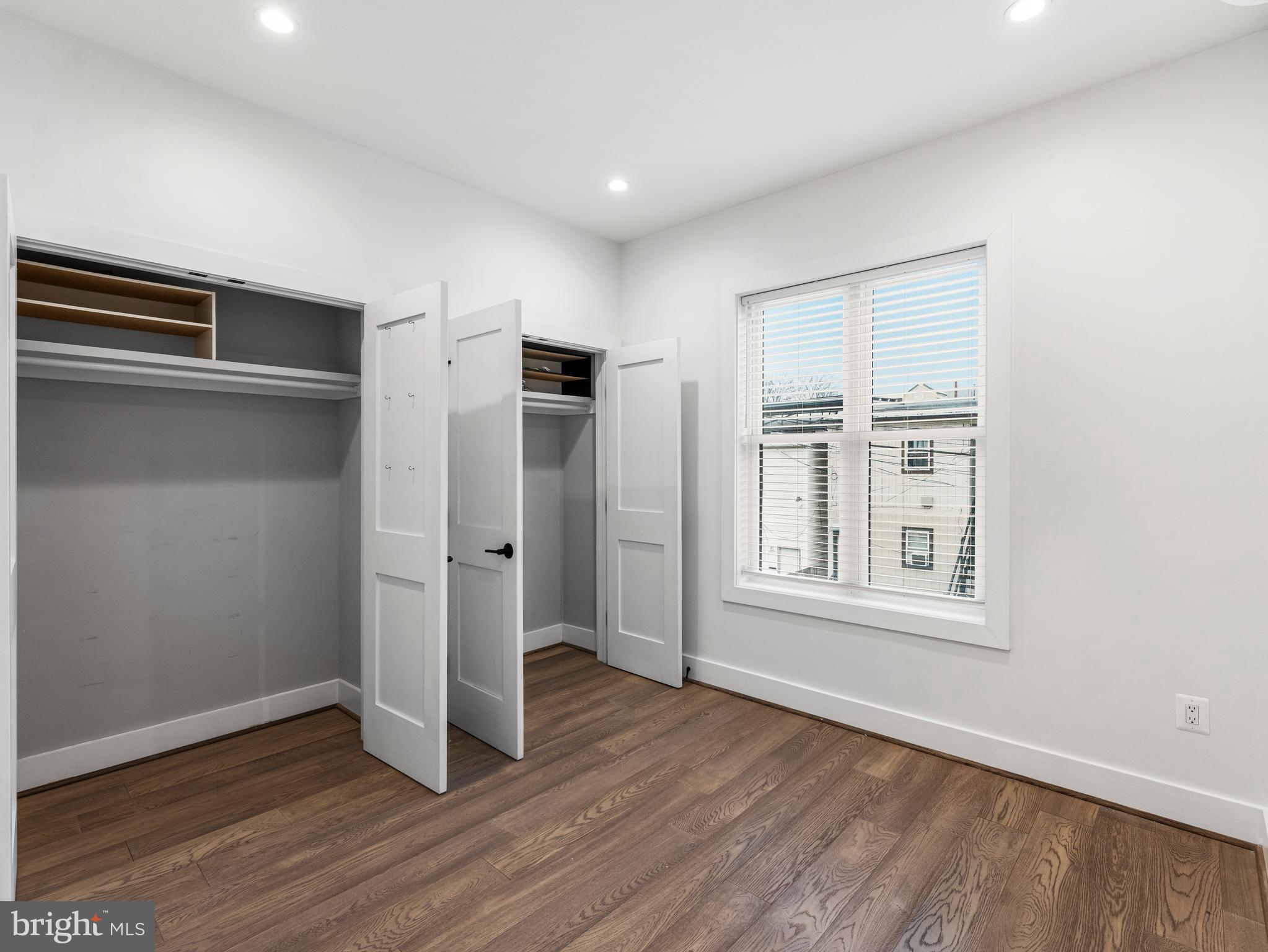 1120 Penn Street Northeast, Unit 2 Washington, DC 20002 - Photo 13 of 14 an empty room with wooden floor cabinet and windows