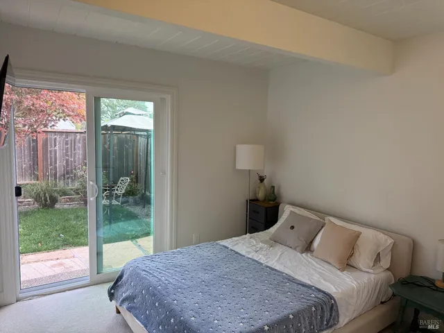 a bedroom with a bed and a large window
