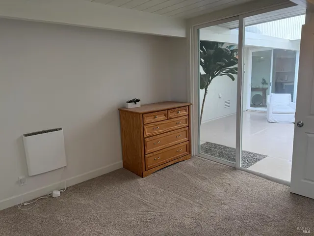 an empty room with a dresser