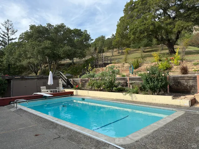 a view of a swimming pool with a lake view