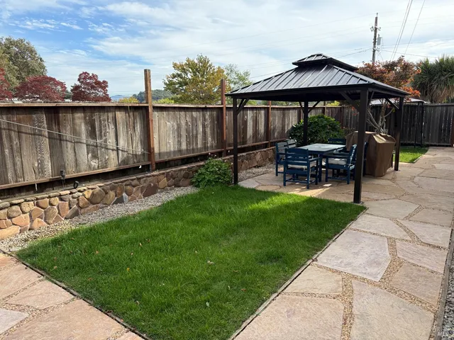 a view of a chair and table on the garden