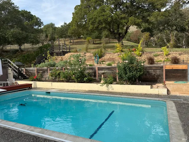 a view of a swimming pool with a yard