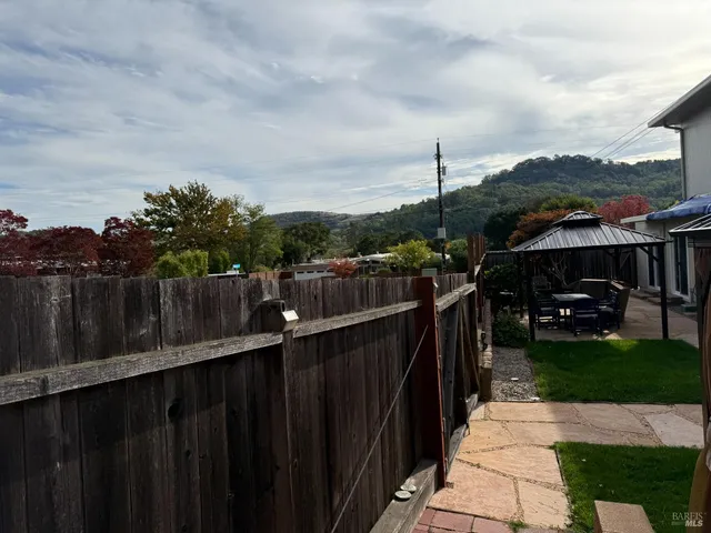 a living room with furniture a window and a potted plant