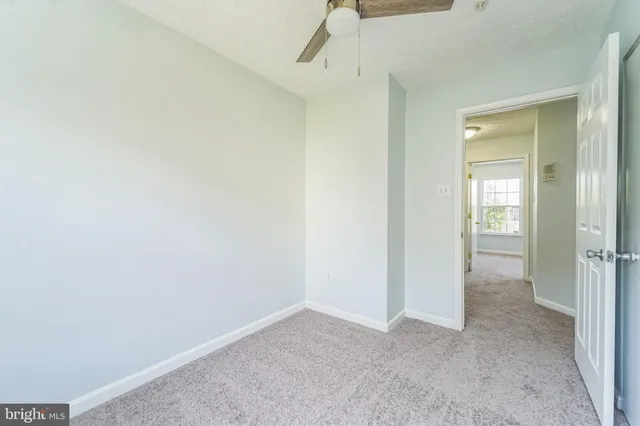 an empty room that has a grey walls