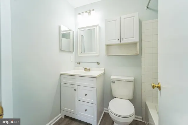 a white toilet sitting next to a bath tub