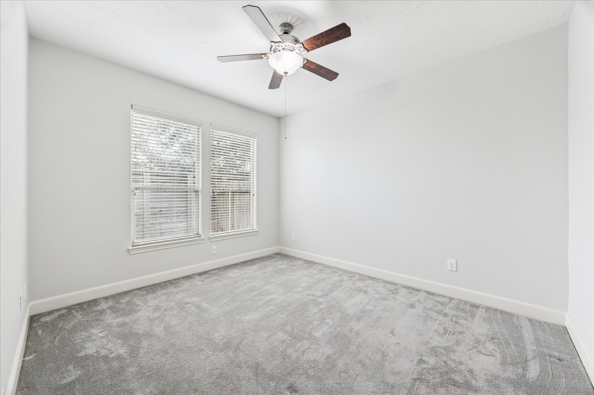 1216 Sampson Street Houston, TX 77003 - Photo 12 of 36 an empty room with a window and a fan