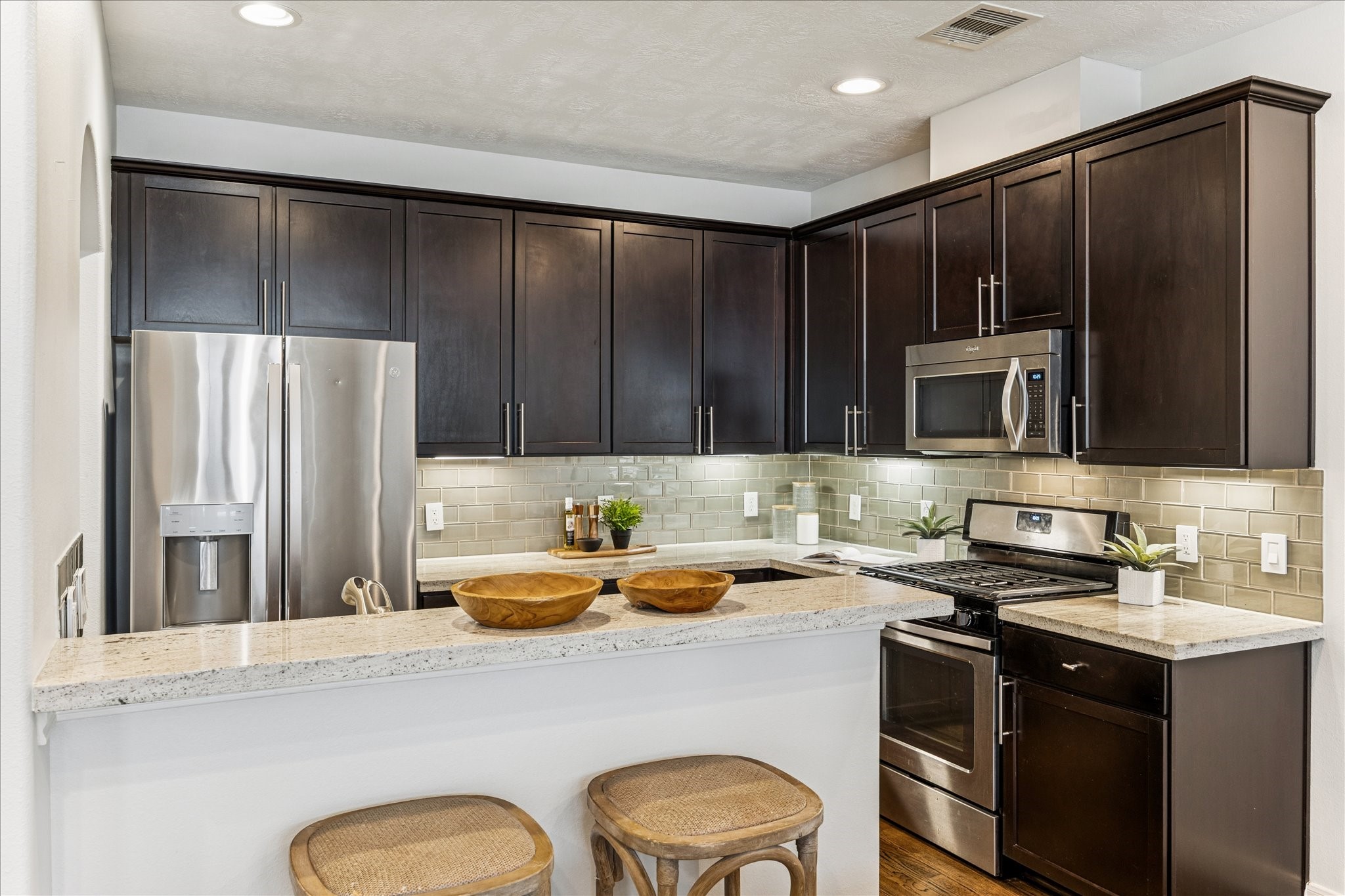 1216 Sampson Street Houston, TX 77003 - Photo 18 of 36 a kitchen with a sink a stove a refrigerator and black cabinets
