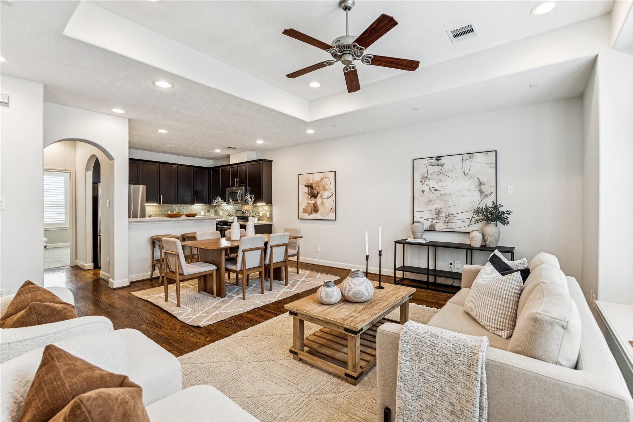 1216 Sampson Street Houston, TX 77003 - Photo 25 of 36 From the living space, the home opens into a beautifully appointed kitchen and dining area, highlighted by recessed lighting, dark wood cabinetry, and sleek countertops.
