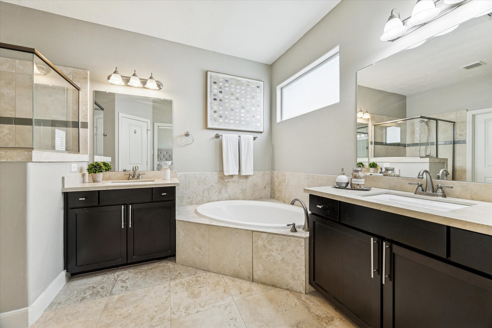 1216 Sampson Street Houston, TX 77003 - Photo 5 of 36 a bathroom with a sink double vanity granite tub shower and a mirror