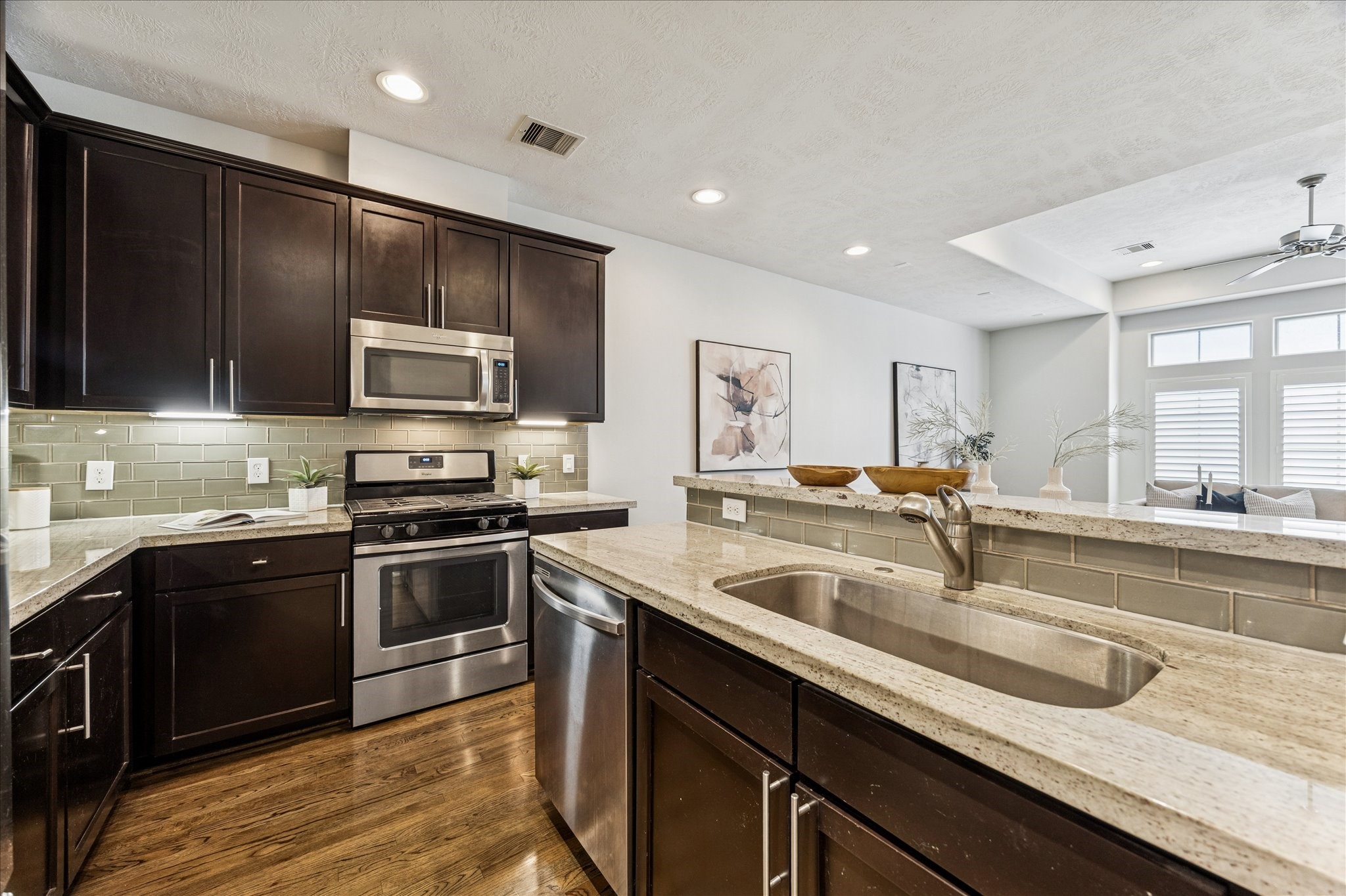 1216 Sampson Street Houston, TX 77003 - Photo 7 of 36 a kitchen with stainless steel appliances granite countertop a sink and stove top oven