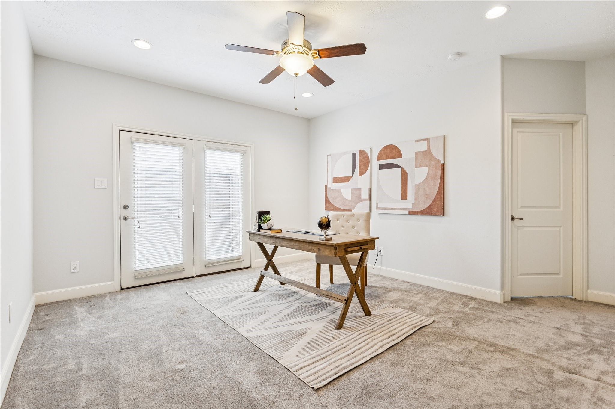 1216 Sampson Street Houston, TX 77003 - Photo 10 of 36 First floor living space is ideal for a home office or flex space. The versatile secondary room features plush carpeting, recessed lighting, and French doors. The room offers generous proportions and a neutral palette ready for personalization.