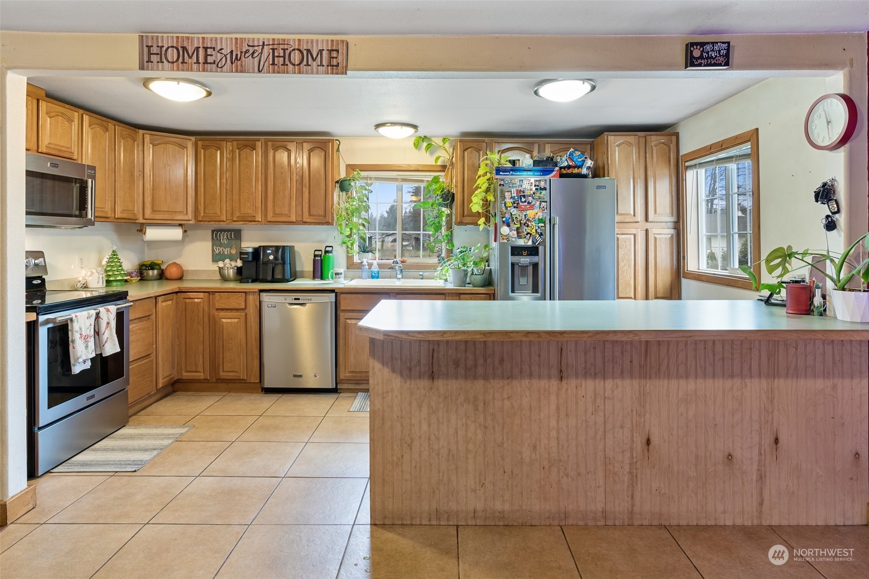 18116 Corvallis Street Southwest Rochester, WA 98579 - Photo 12 of 26 a kitchen with stainless steel appliances granite countertop a stove a sink dishwasher and a microwave