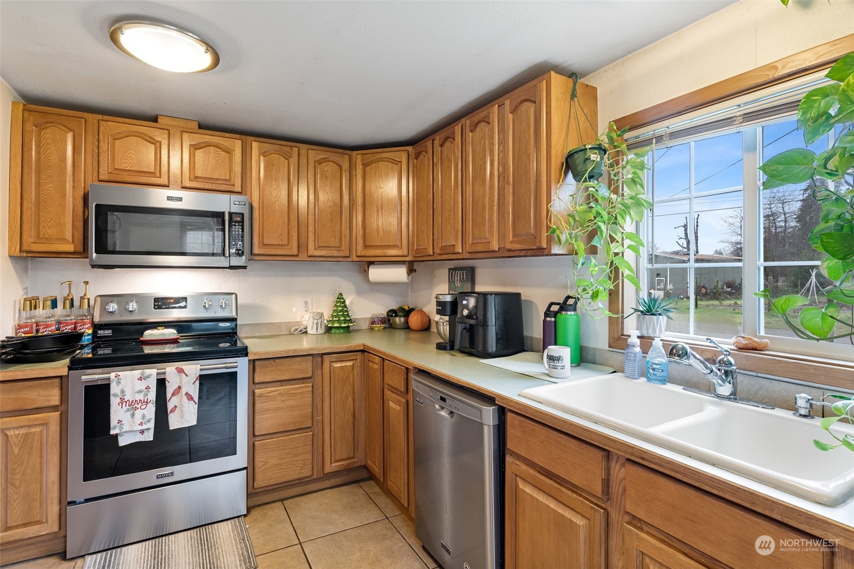18116 Corvallis Street Southwest Rochester, WA 98579 - Photo 14 of 26 a kitchen with a sink stove top oven and glass door