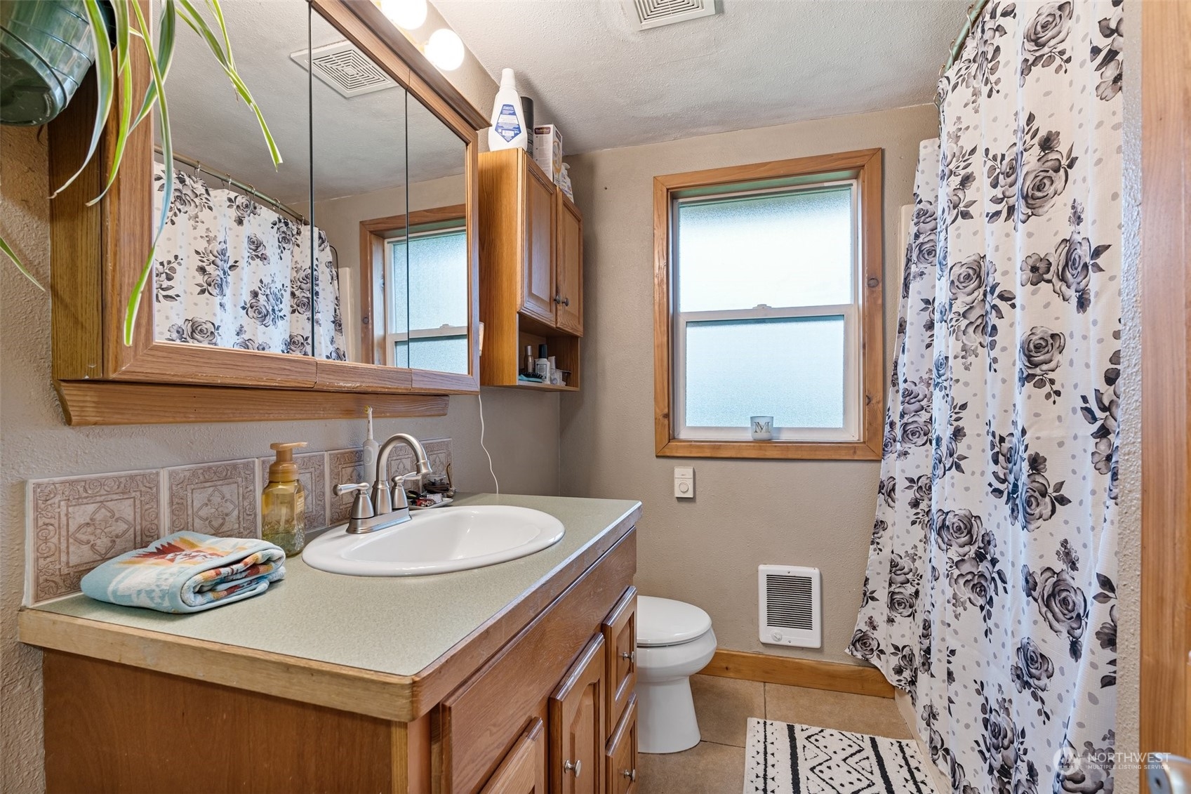 18116 Corvallis Street Southwest Rochester, WA 98579 - Photo 18 of 26 a bathroom with a sink toilet and mirror