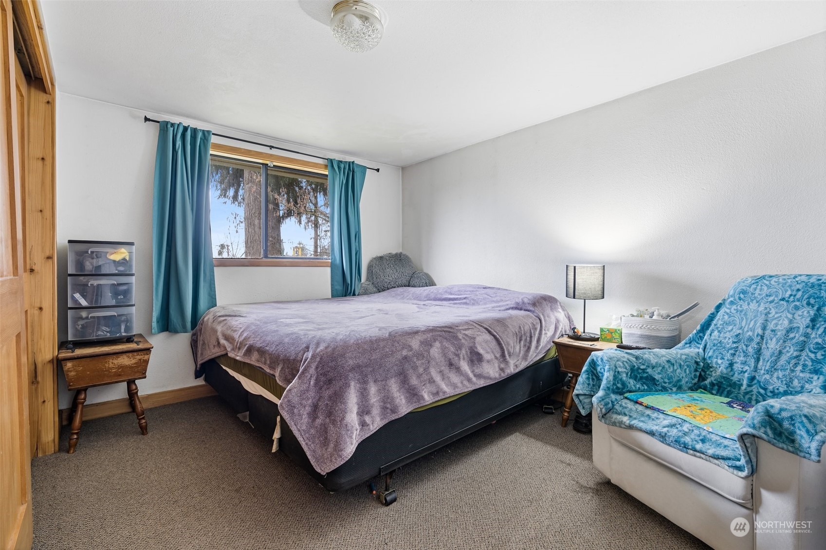 18116 Corvallis Street Southwest Rochester, WA 98579 - Photo 19 of 26 a living room with a bed furniture and a window