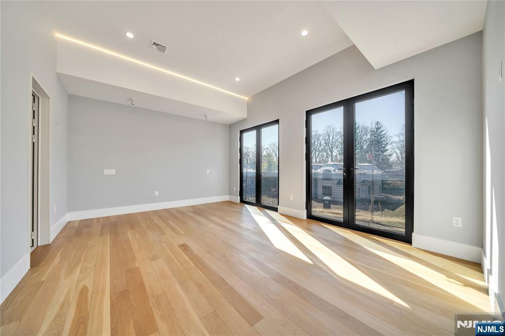 11 Roberts Road Englewood Cliffs, NJ 07632 - Photo 32 of 50 a view of an empty room with wooden floor and a window