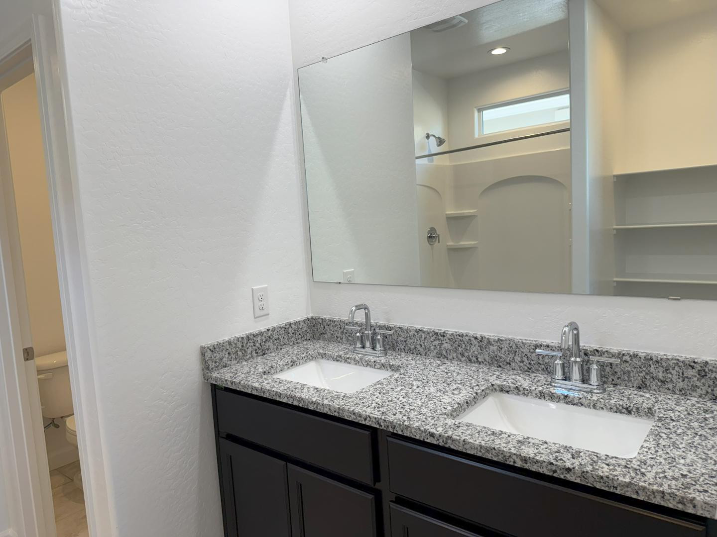 1840 West Spaulding Avenue Apache Junction, AZ 85120 - Photo 30 of 53 a bathroom with a granite countertop sink and a mirror