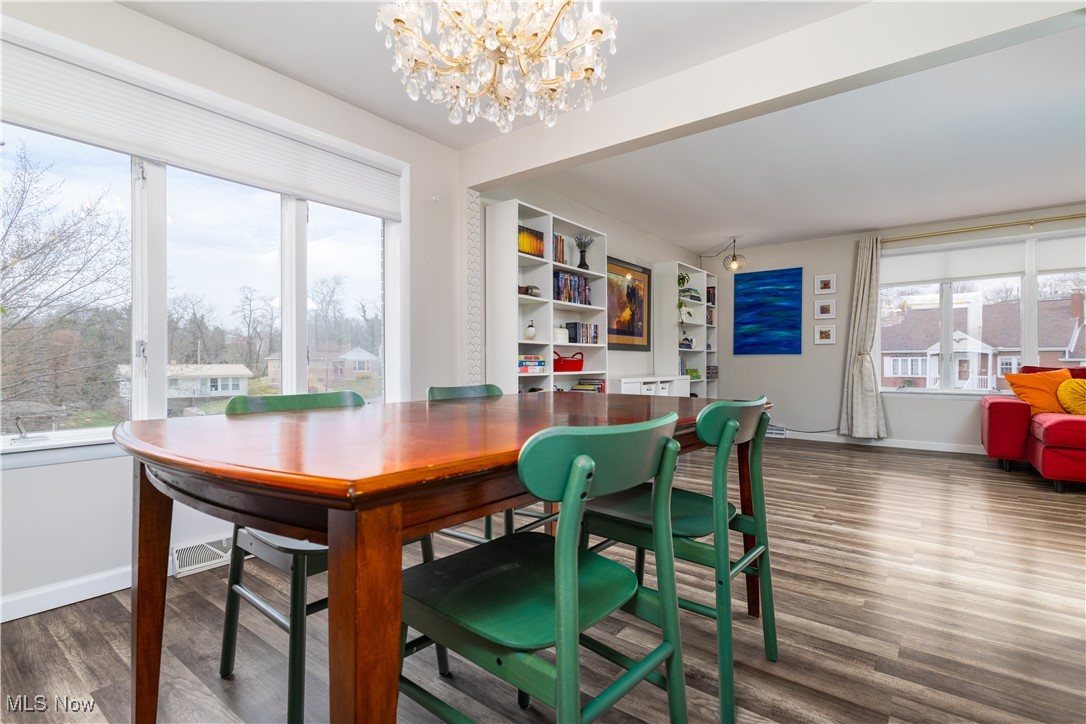 137 Preston Road Steubenville, OH 43953 - Photo 21 of 38 Dining space featuring a chandelier, wood finished floors, and a healthy amount of sunlight