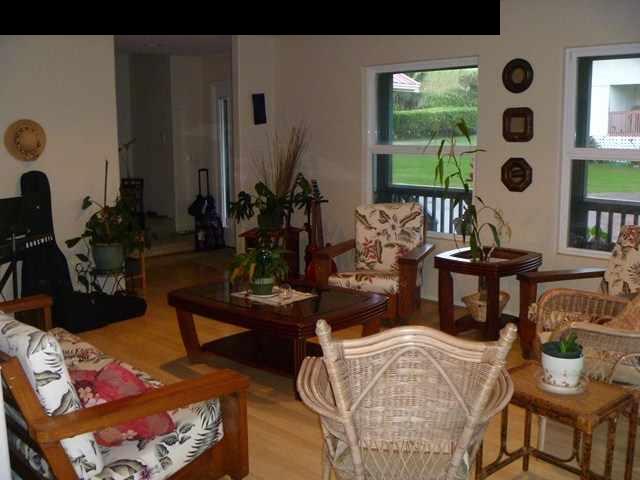 1200 Kokomo Road Haiku, HI 96708 - Photo 11 of 24 a living room with furniture and floor to ceiling windows