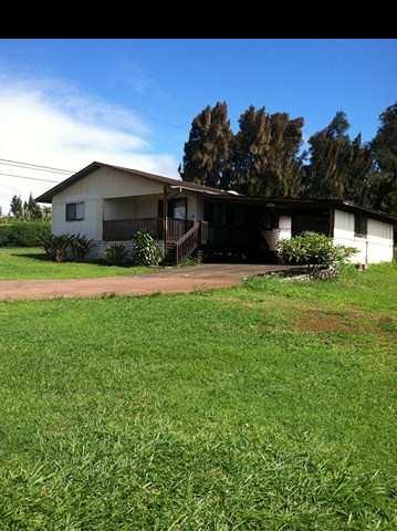 1200 Kokomo Road Haiku, HI 96708 - Photo 6 of 24 a front view of a house with a yard and garage
