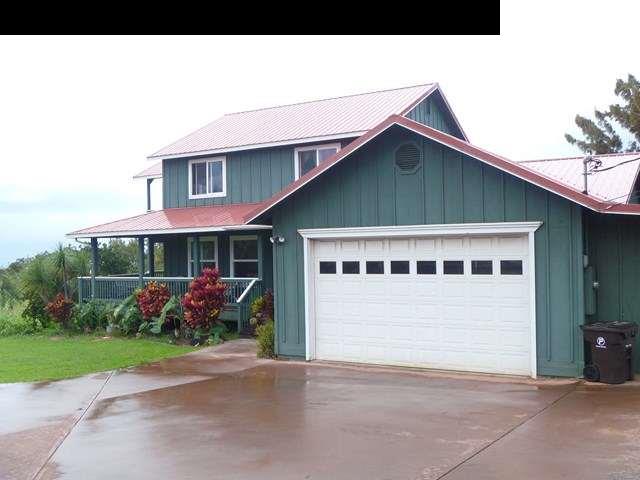 1200 Kokomo Road Haiku, HI 96708 - Photo 9 of 24 a front view of a house with a yard and garage