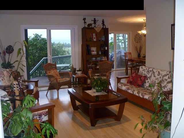 1200 Kokomo Road Haiku, HI 96708 - Photo 10 of 24 a living room with furniture and wooden floor