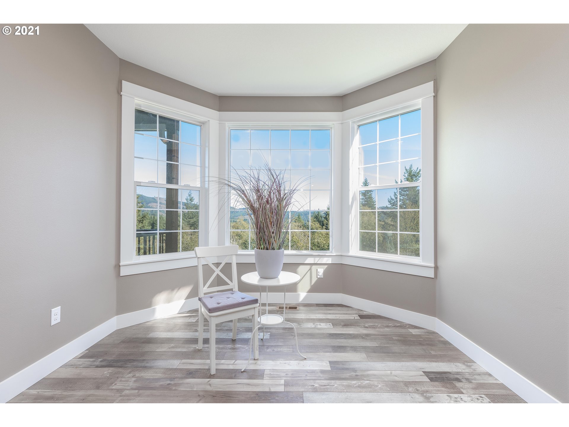31501 Northeast 69th Street Camas, WA 98607 - Photo 22 of 32 a view of empty room with wooden floor and windows