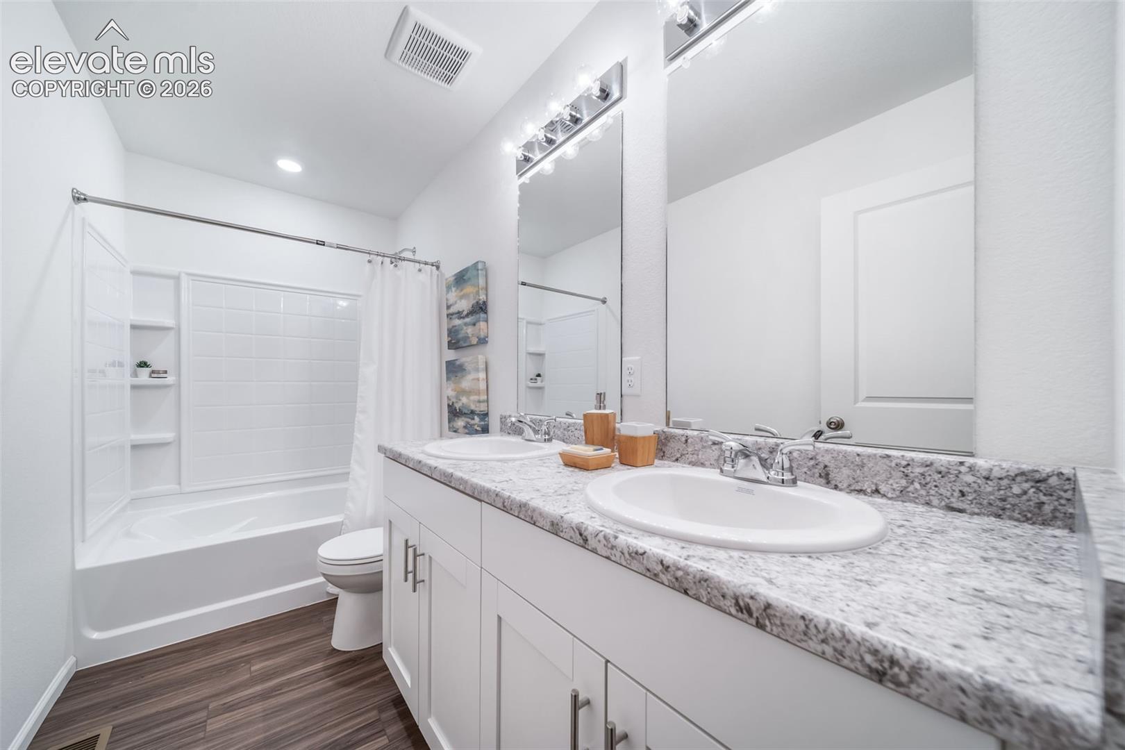4936 Truscott Road Colorado Springs, CO 80925 - Photo 21 of 41 Dual vanity with white cabinetry, light-toned countertop, and undermount sinks
*photos of a model home*