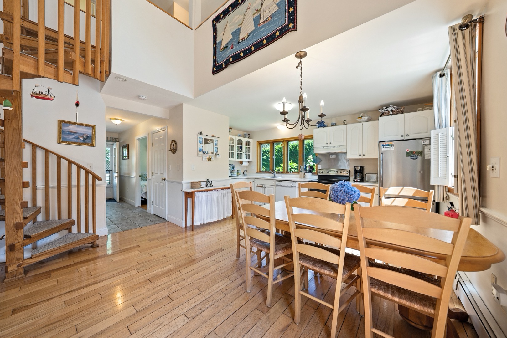 52 Pleasant Street Nantucket, MA 02554 - Photo 11 of 36 a kitchen with stainless steel appliances kitchen island granite countertop a refrigerator a stove a microwave oven a dining table and chairs with wooden floor