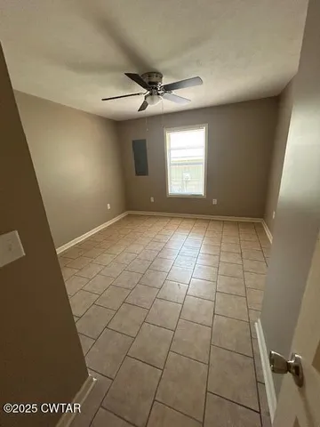 a view of an empty room and a window