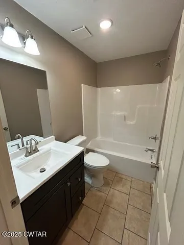 a bathroom with a sink mirror toilet and bathtub
