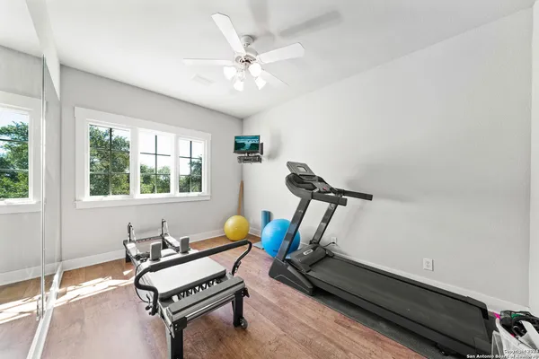a living room with furniture a flat screen tv and a window
