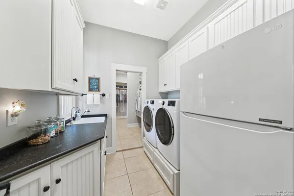 a kitchen with a sink a stove and cabinets