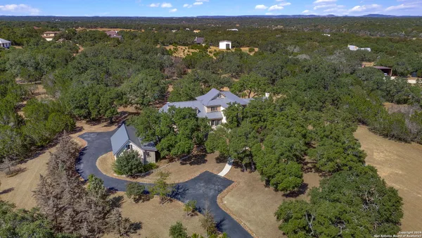 an aerial view of a house with a yard