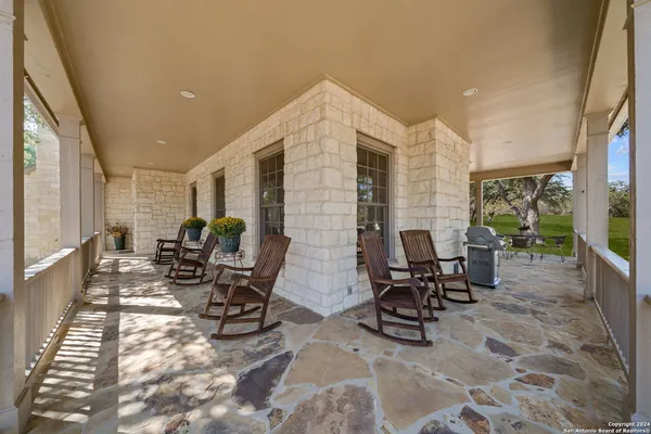 a view of a patio with table and chairs and potted plants