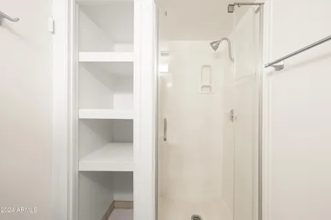 a bathroom with a glass shower door