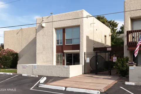 a view of a street with potted plants